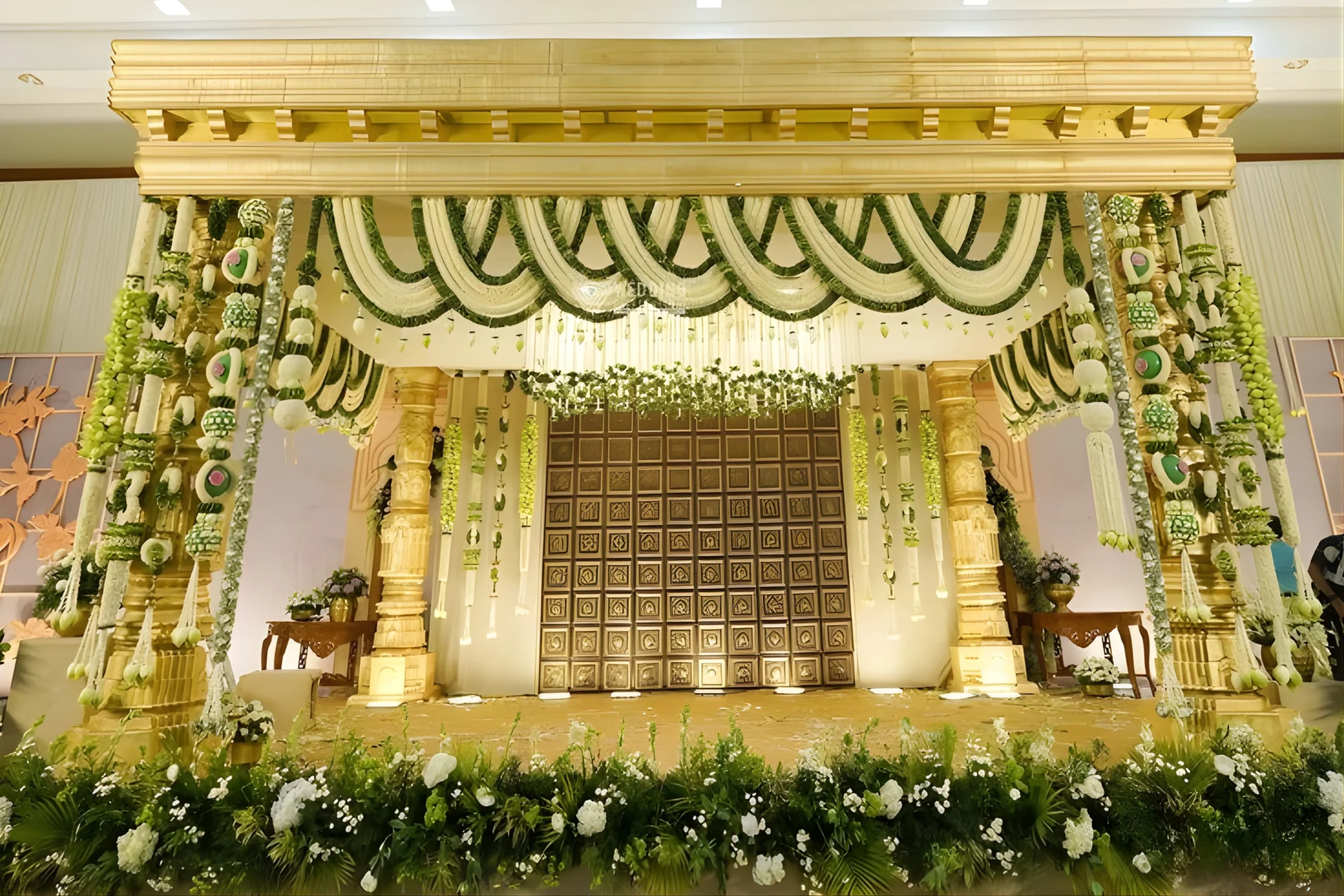 Comparison of plastic flower wedding decor vs fresh marigold and rose floral arrangements at Indian wedding venue